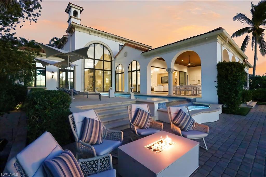 2450 Tarpon Road Naples, FL 34102 - Photo 3 of 26 a front view of a house with garden and patio