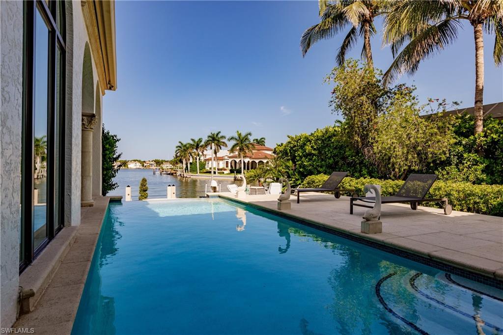 2450 Tarpon Road Naples, FL 34102 - Photo 8 of 26 a view of a swimming pool with a patio