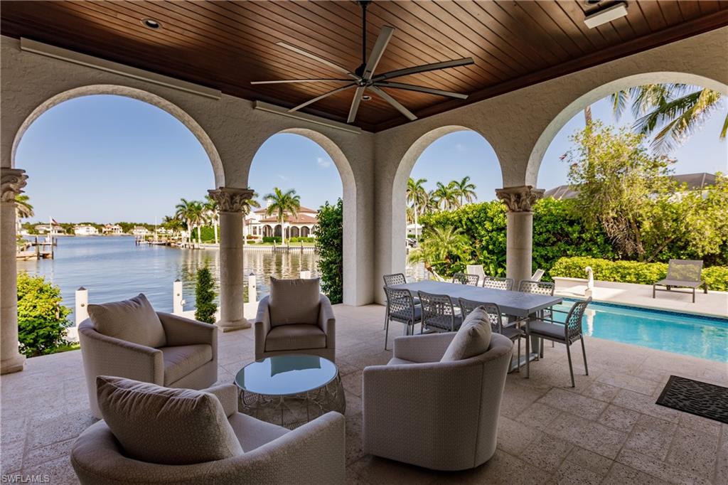 2450 Tarpon Road Naples, FL 34102 - Photo 10 of 26 a living room with couches chairs and a potted plant