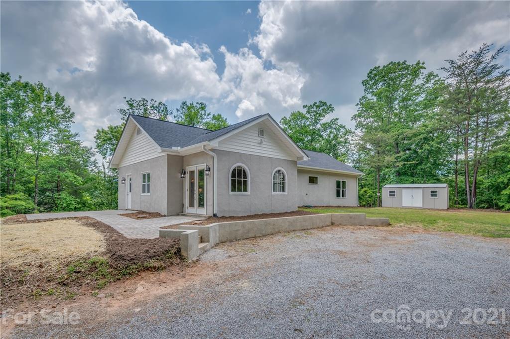 196 Caledonia Road Landrum, SC 29356 - Photo 1 of 26 a view of a house with a yard and large tree