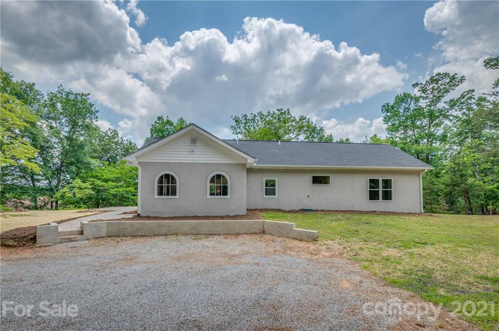 196 Caledonia Road Landrum, SC 29356 - Photo 2 of 26 a house with trees in the background