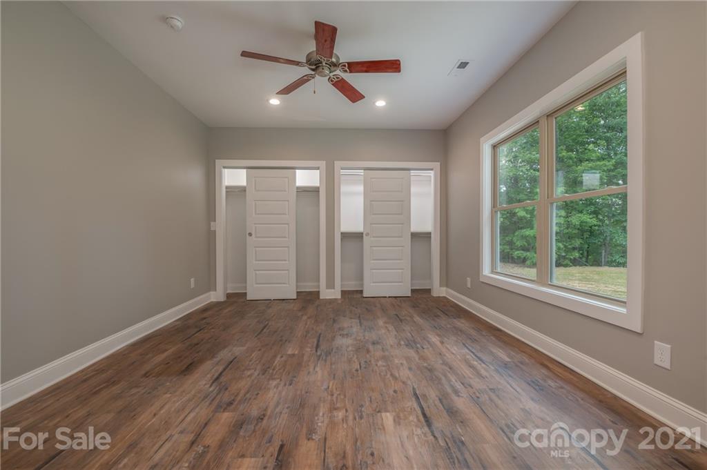 196 Caledonia Road Landrum, SC 29356 - Photo 13 of 26 wooden floor in an empty room with a window