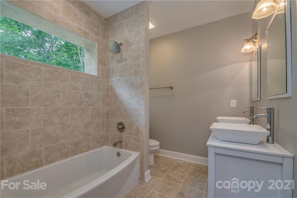 196 Caledonia Road Landrum, SC 29356 - Photo 15 of 26 a bathroom with a sink a toilet and bathtub
