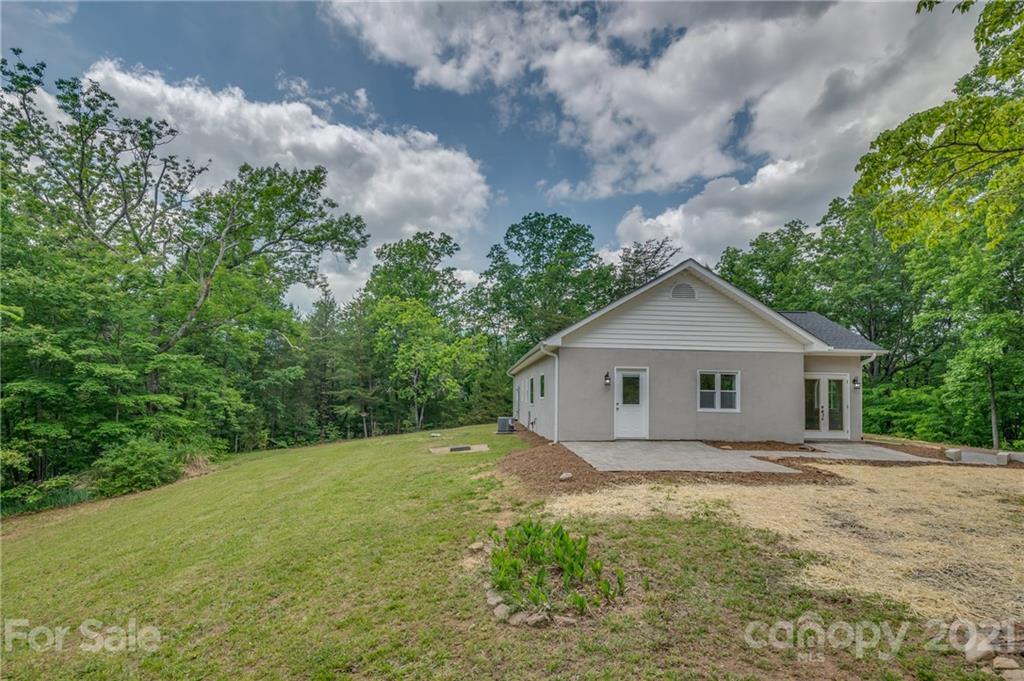 196 Caledonia Road Landrum, SC 29356 - Photo 21 of 26 a view of house with backyard and garden