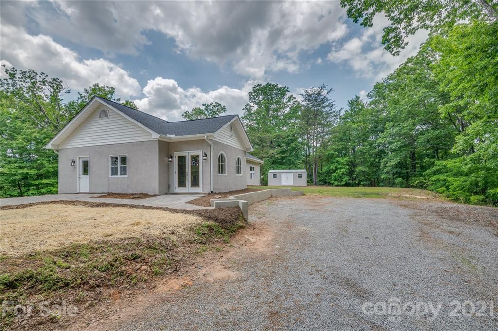 196 Caledonia Road Landrum, SC 29356 - Photo 24 of 26 a view of a house with a yard and large trees