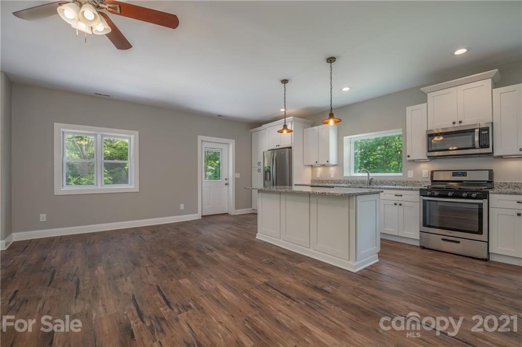 196 Caledonia Road Landrum, SC 29356 - Photo 5 of 26 a kitchen with stainless steel appliances granite countertop a stove a sink and a refrigerator