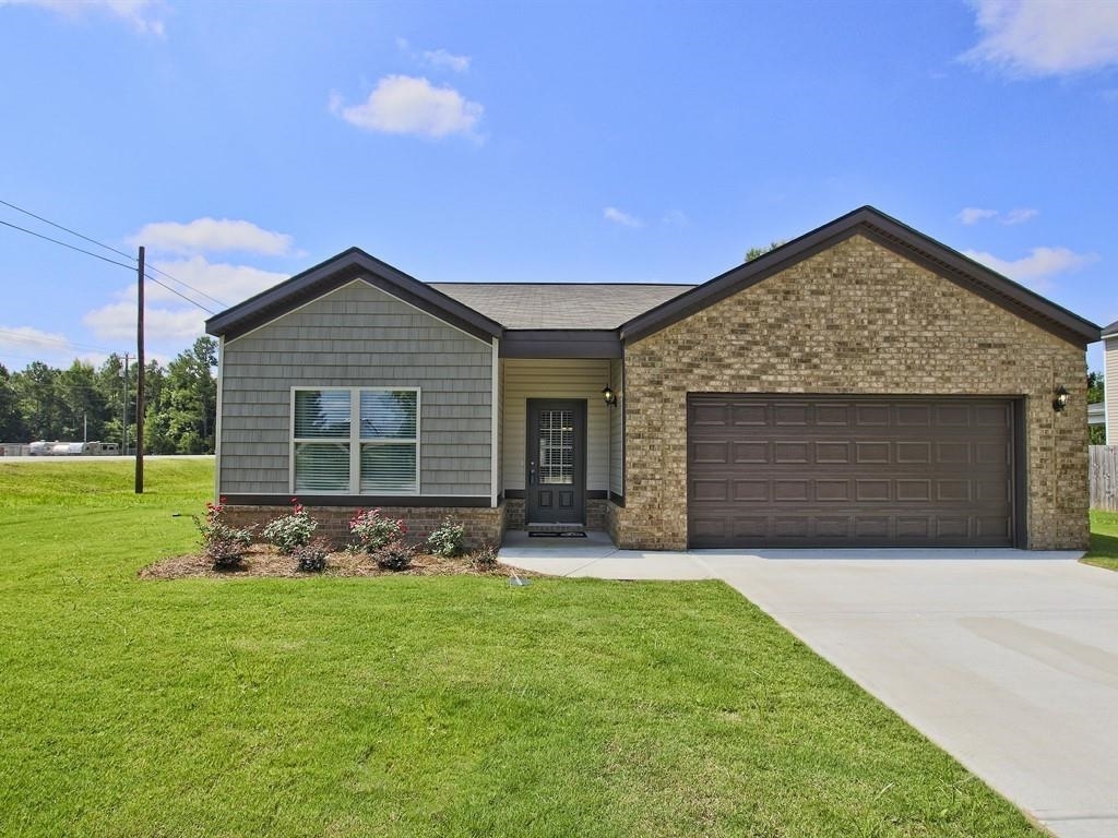 103 Longbridge Way, Unit 1 Perry, GA 31069 - Photo 1 of 1 a front view of a house with a garden and yard