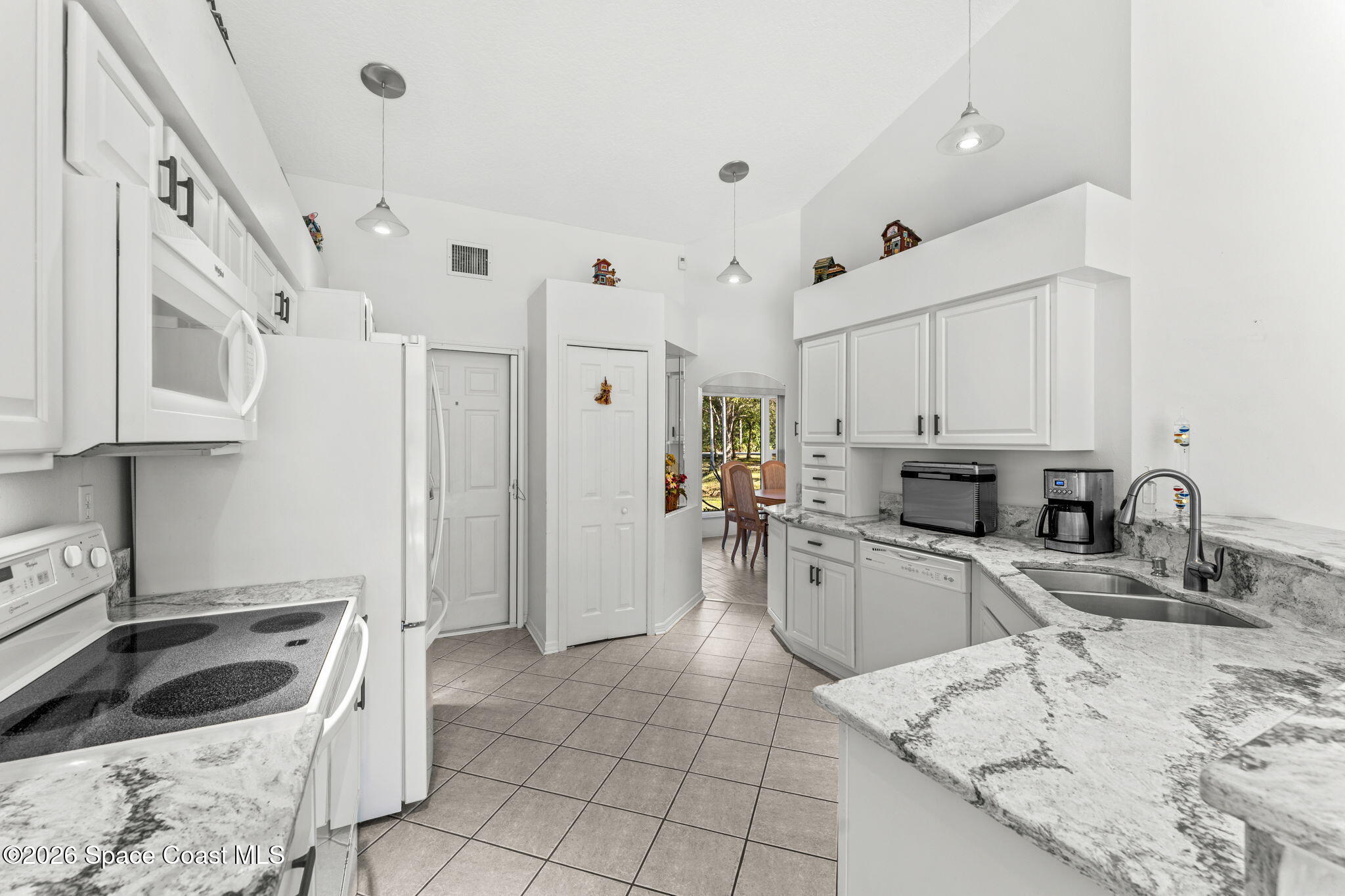4250 Pine Street Cocoa, FL 32926 - Photo 13 of 30 a kitchen with granite countertop a sink a stove and refrigerator