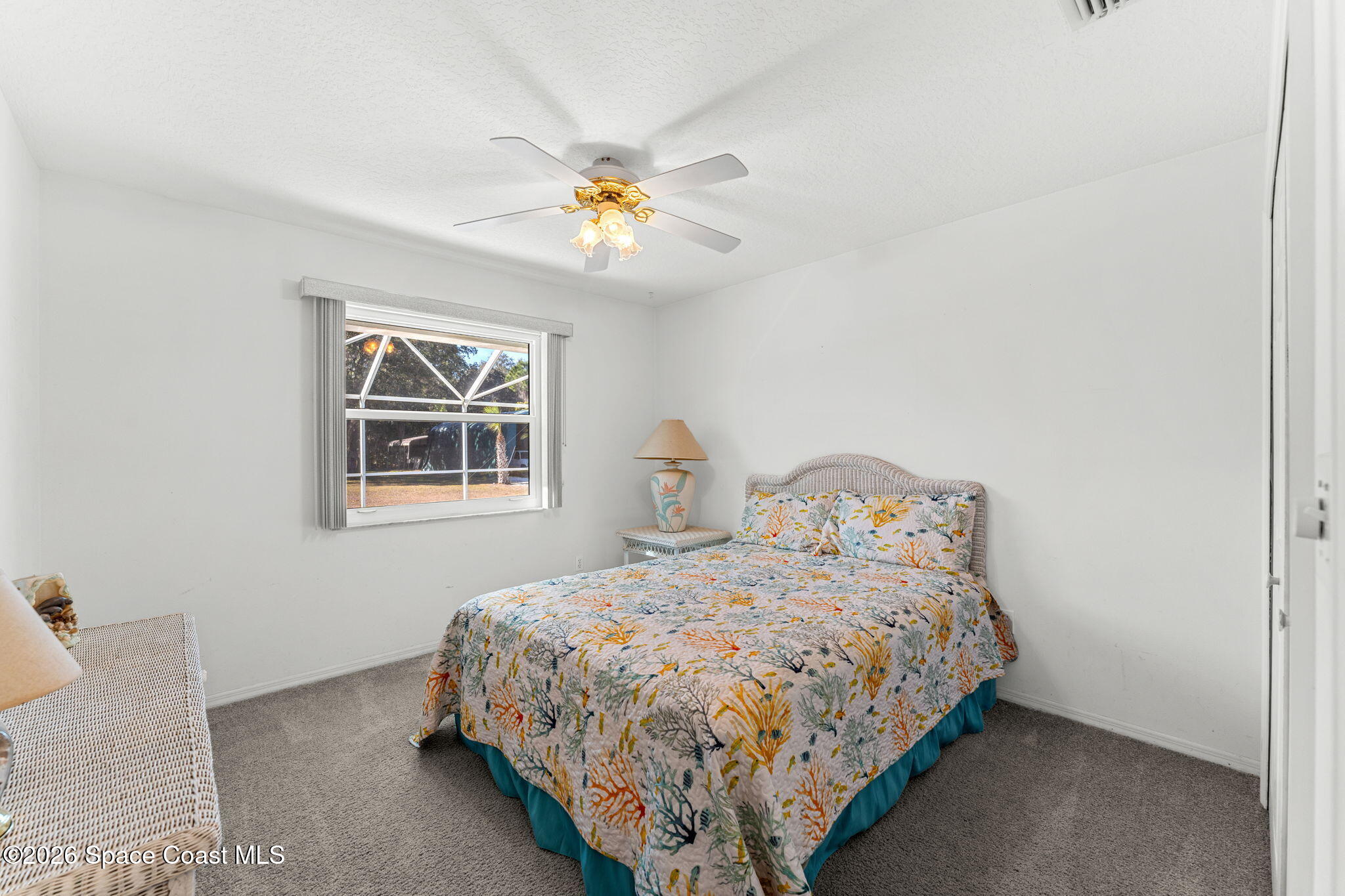 4250 Pine Street Cocoa, FL 32926 - Photo 17 of 30 a bedroom with a bed and a chandelier