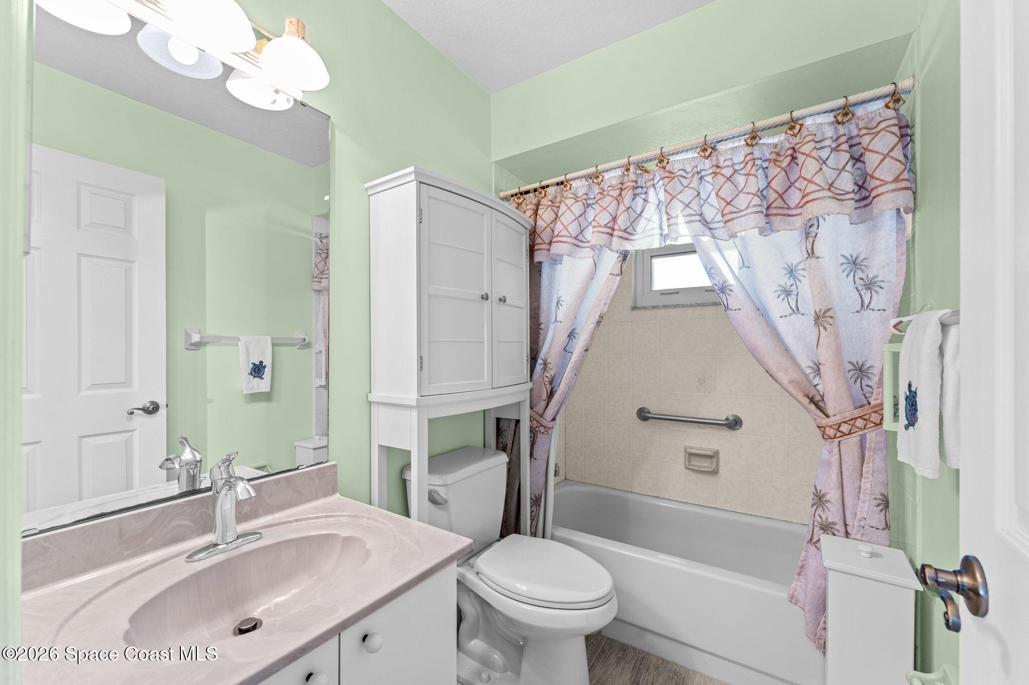 4250 Pine Street Cocoa, FL 32926 - Photo 19 of 30 a bathroom with a sink a toilet a large mirror and shower