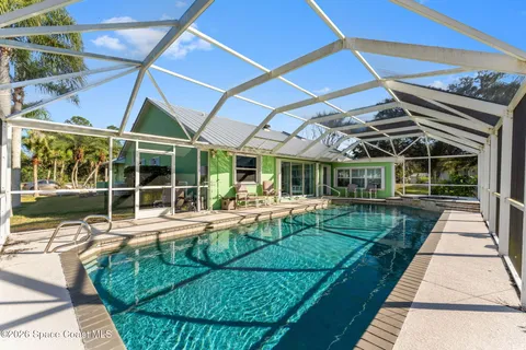 a view of a house with backyard porch and sitting area