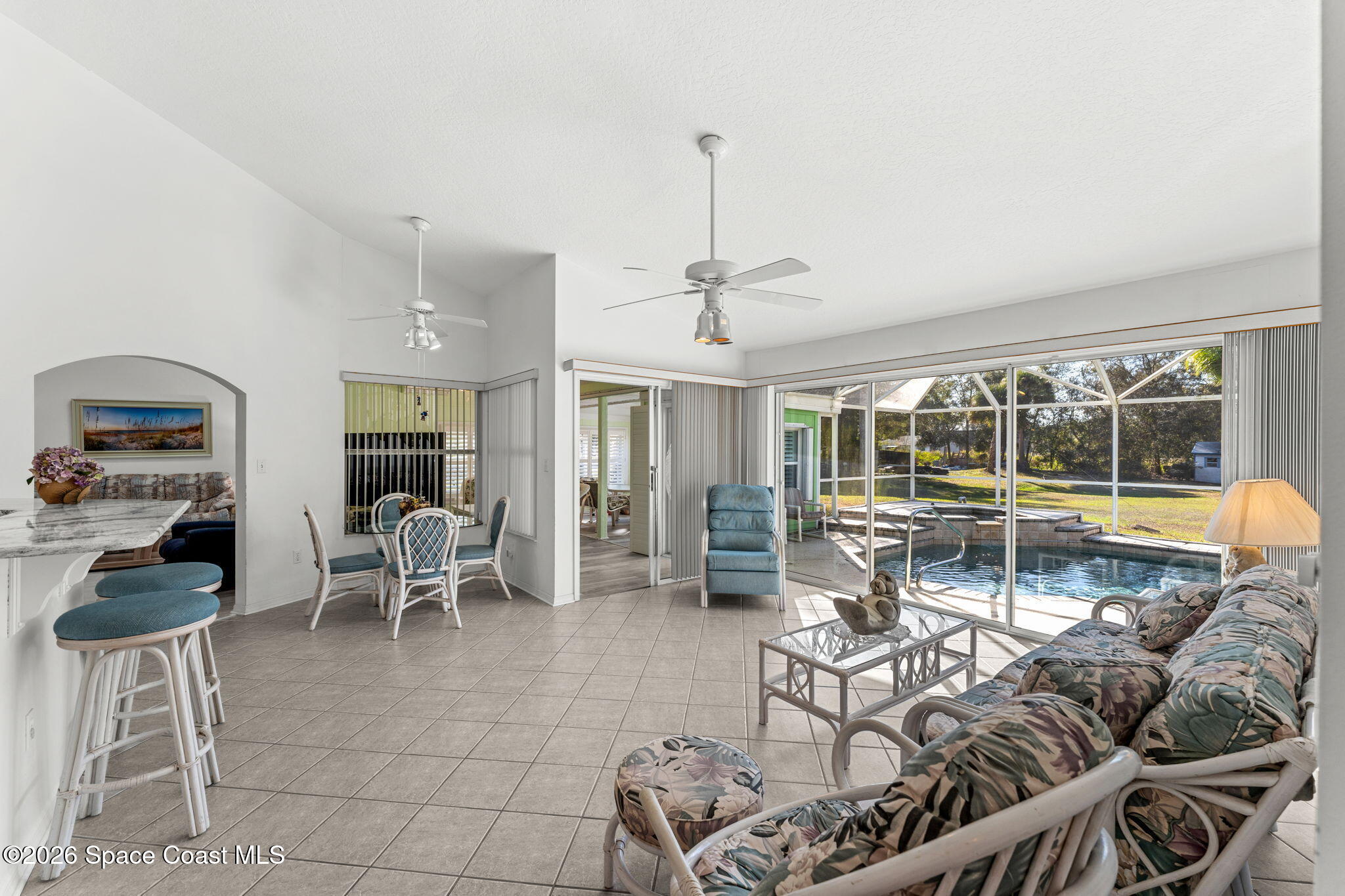 4250 Pine Street Cocoa, FL 32926 - Photo 9 of 30 a living room with furniture a flat screen tv and a large window