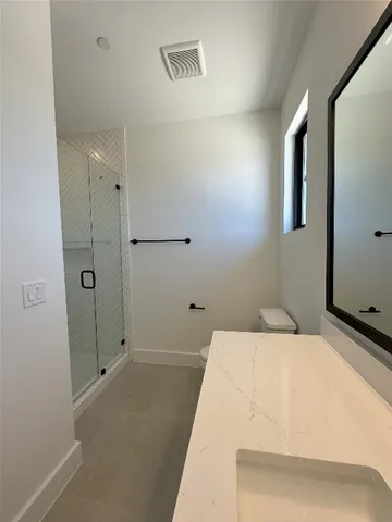 an empty room with a window and a ceiling fan