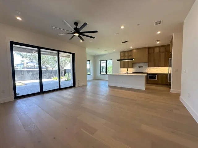 a view of a living room and kitchen with a large window