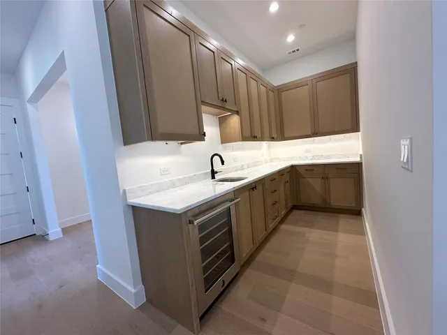 a kitchen with a sink and a refrigerator