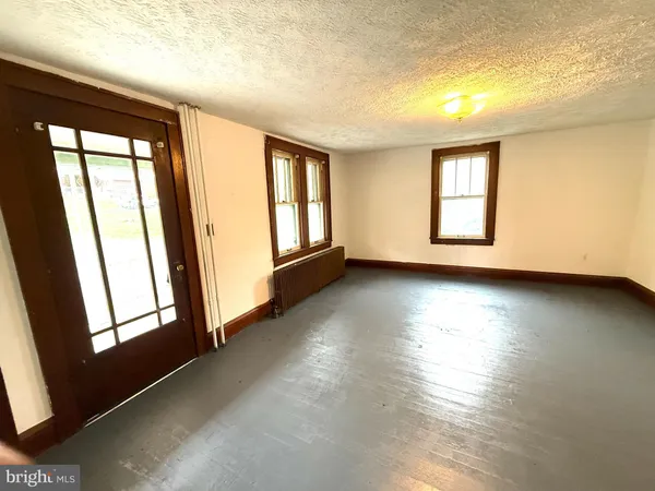a view of room with window and wooden floor