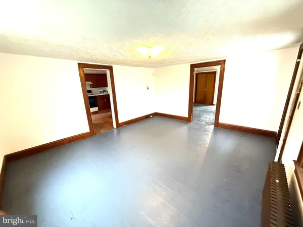 a view of an empty room and wooden floor