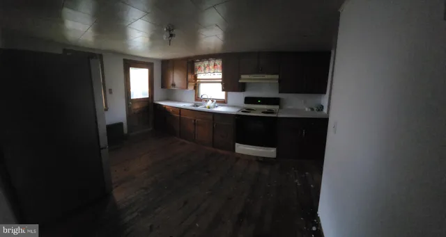 a kitchen with stainless steel appliances a sink stove and refrigerator