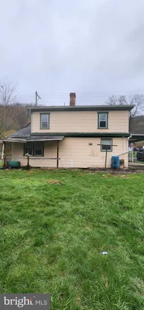 a view of a yard with a house in the background