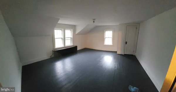 an empty room with windows and closet