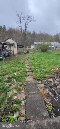 a view of a garden with a building in the background