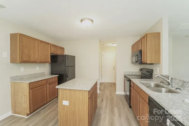 a kitchen with a sink stove and refrigerator