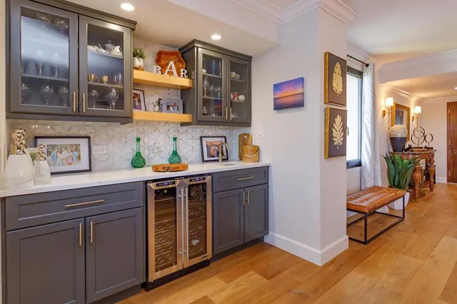 a view of kitchen with stainless steel appliances cabinets and wooden floor