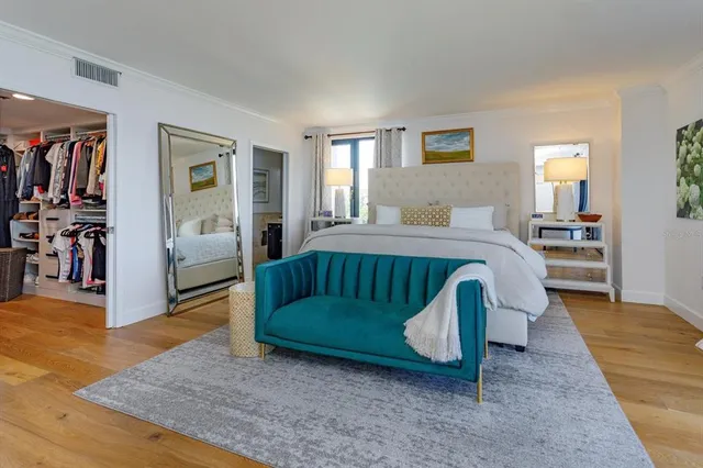 a bedroom with a bed and a view of living room