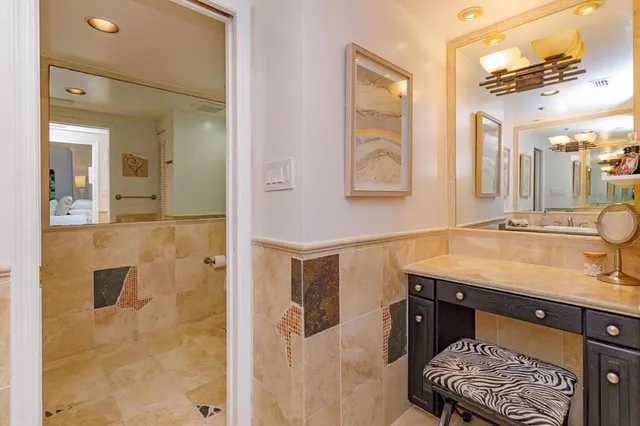 a bathroom with a sink a mirror and a shower