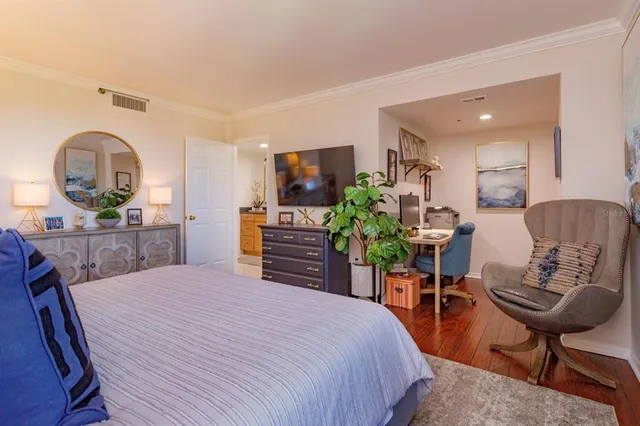 a bedroom with a bed and a chair