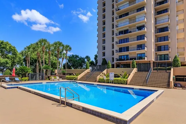 a living room with furniture a flat screen tv and a large window