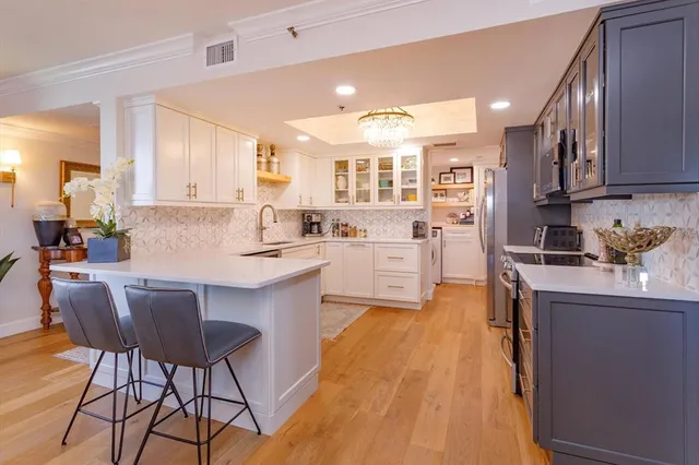a kitchen with stainless steel appliances kitchen island granite countertop a sink and cabinets