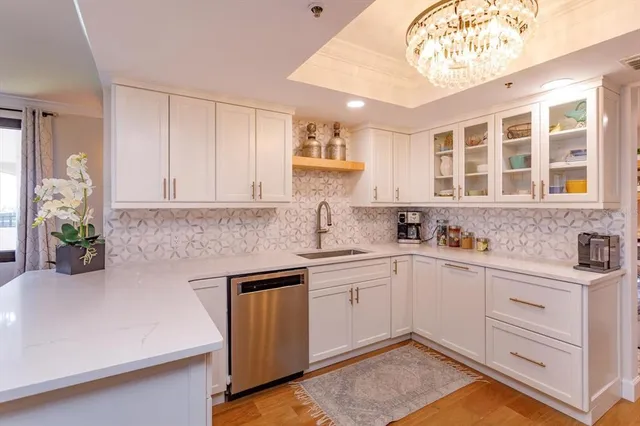 a kitchen with stainless steel appliances granite countertop a sink and cabinets
