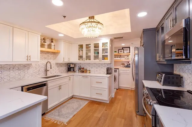 a kitchen with stainless steel appliances granite countertop a stove and a sink