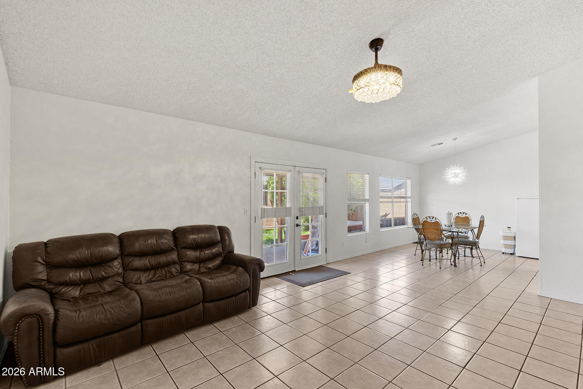 9002 West Coronado Road Phoenix, AZ 85037 - Photo 23 of 54 a living room with furniture a dining table and a large window