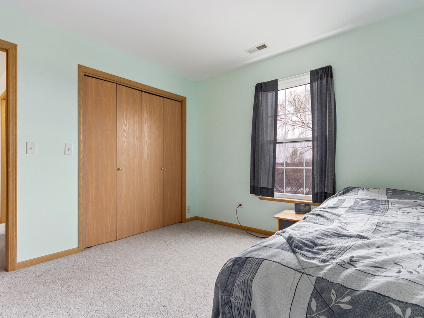 4709 West Iris Lane Monee, IL 60449 - Photo 22 of 28 a bedroom with a bed and a window