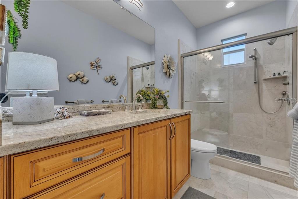 2172 Deborah Drive Punta Gorda, FL 33950 - Photo 37 of 61 a bathroom with a granite countertop sink a toilet and shower