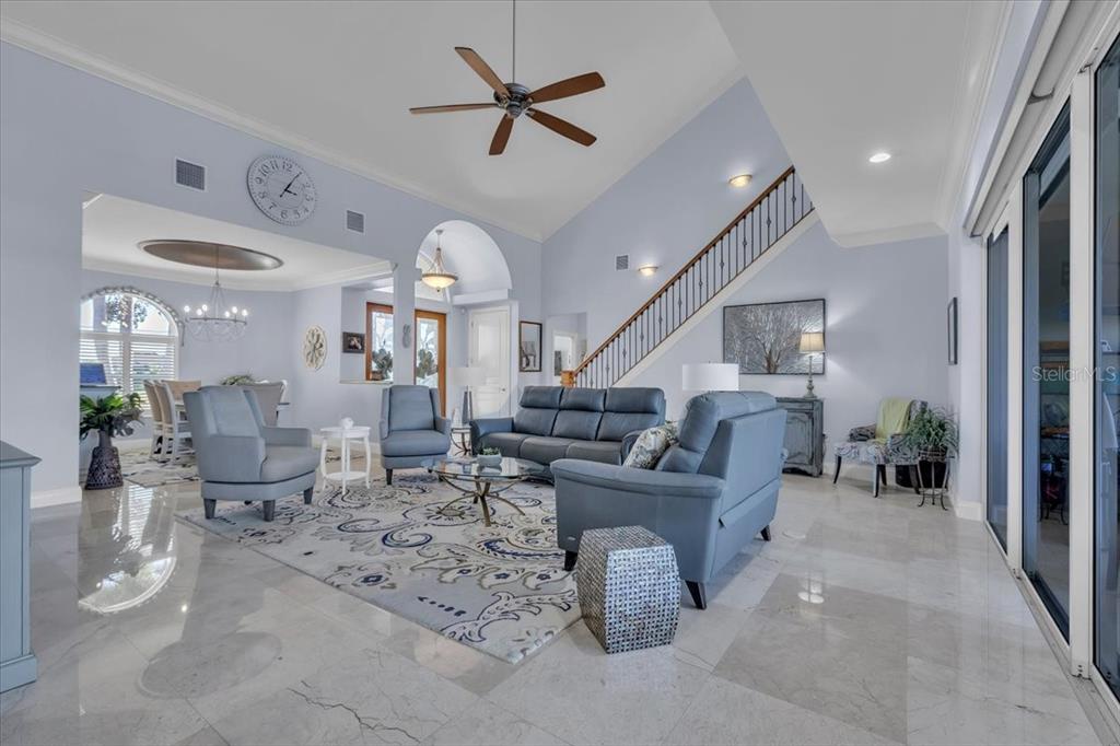 2172 Deborah Drive Punta Gorda, FL 33950 - Photo 4 of 61 a living room with lots of furniture and a chandelier