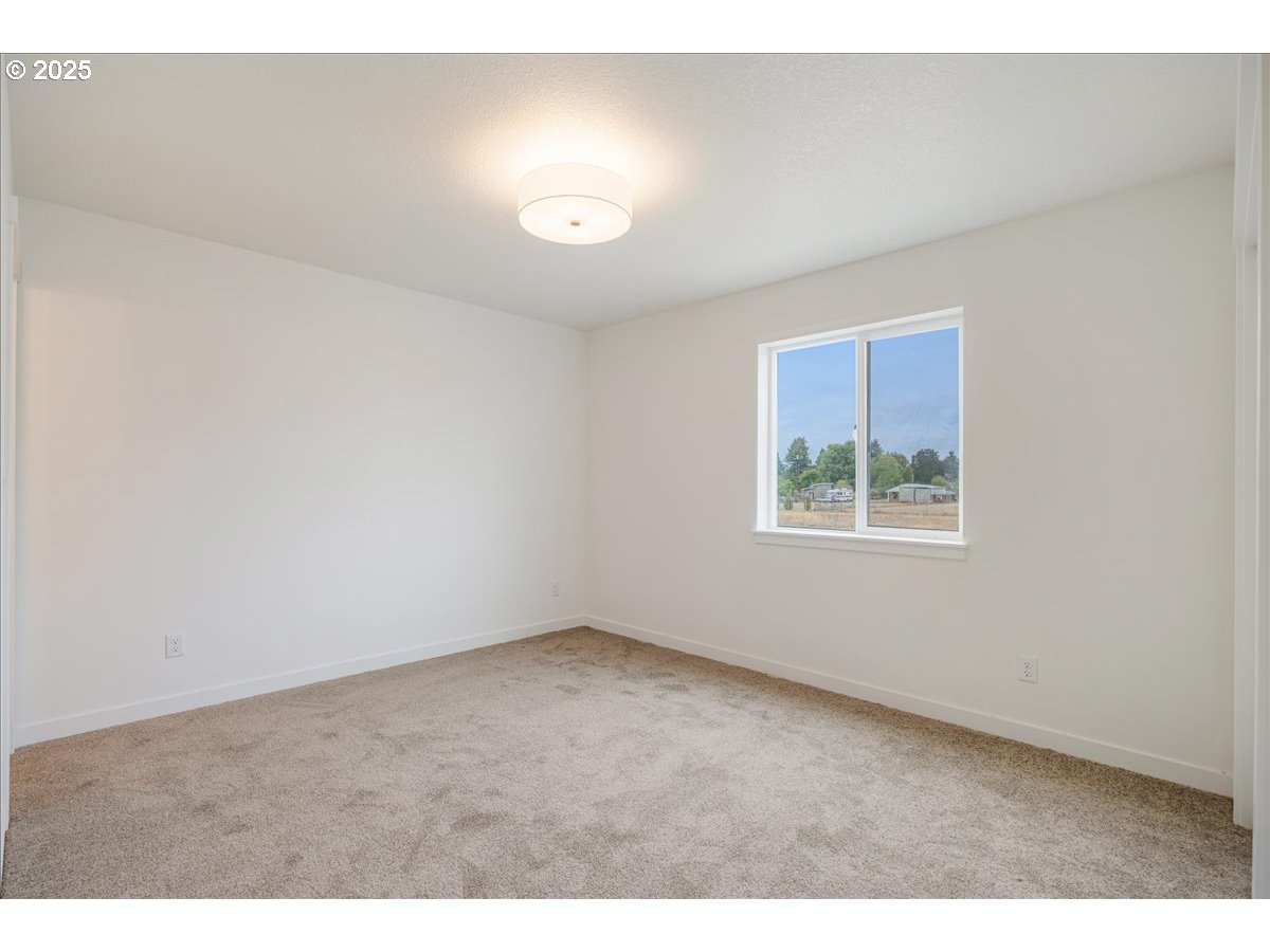 357 Southeast Kitzmiller Drive Dallas, OR 97338 - Photo 7 of 8 an empty room with windows