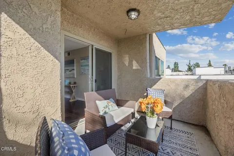 a outdoor living space with furniture and a ceiling fan