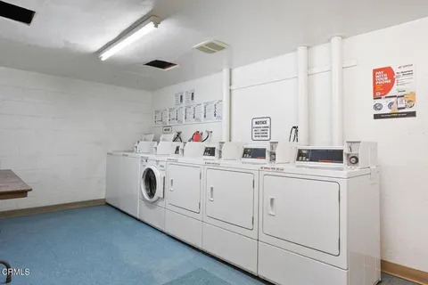 a utility room with cabinets washer and dryer