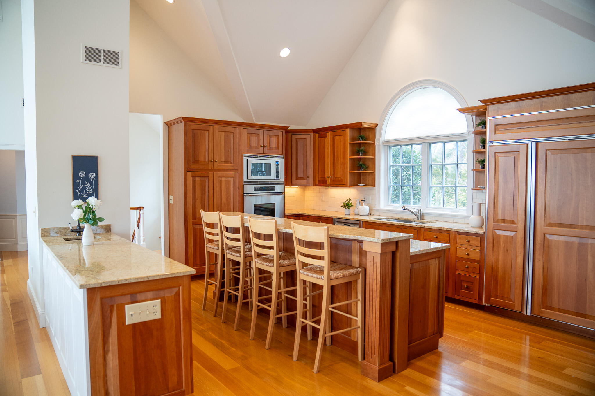 48 South Chatham Road Harwich, MA 02645 - Photo 23 of 54 a kitchen with stainless steel appliances granite countertop wooden floor and a refrigerator