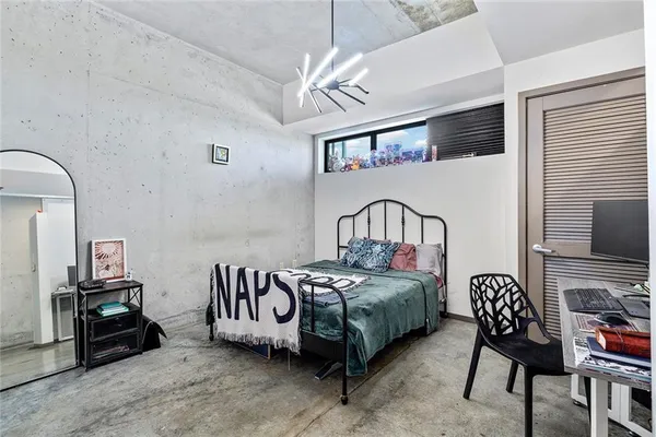 a bedroom with furniture and a flat screen tv