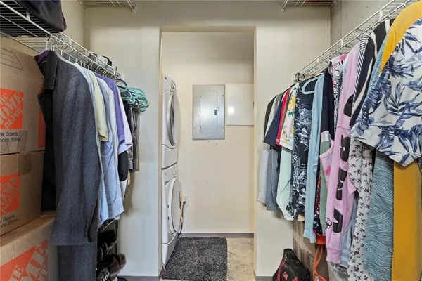 a view of walk in closet with clothes and shoes