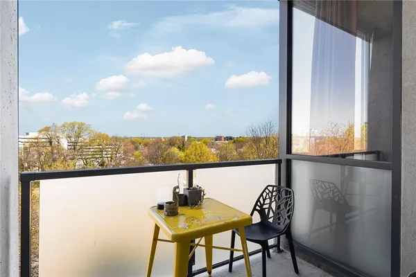a view of a balcony with table and chairs