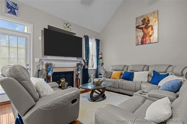 a living room with furniture a rug and a window