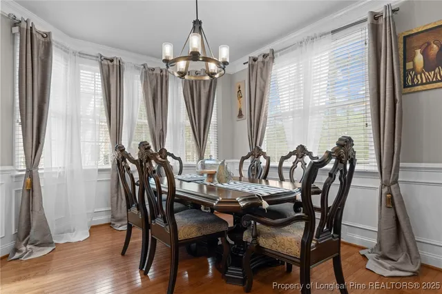 a view of a dining room with furniture and chandelier