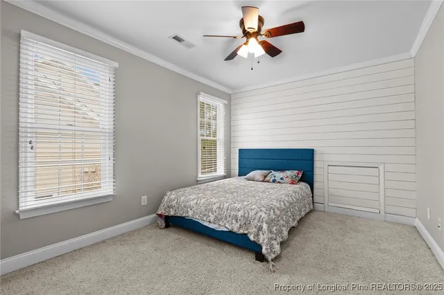 a bedroom with a bed and a ceiling fan