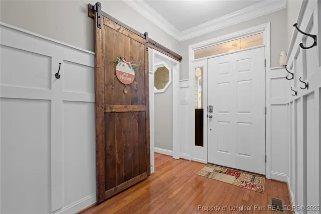 a view of entryway with wooden floor and stairs