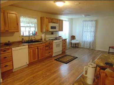 a kitchen with a sink appliances and cabinets